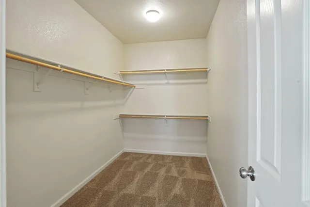 an empty room with windows and cabinet