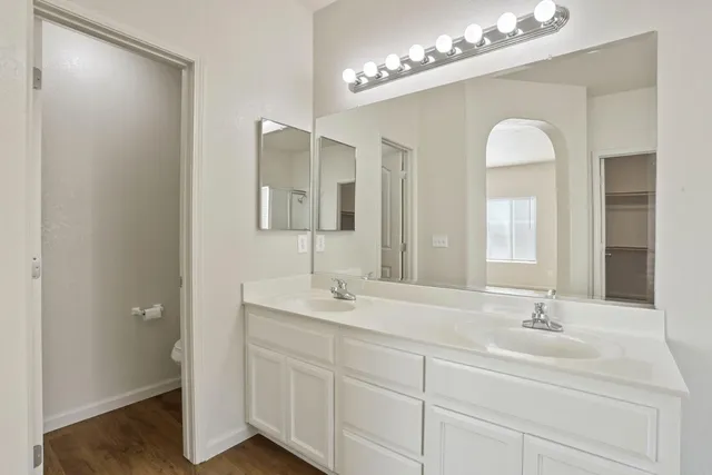 a view of an empty room with a chandelier fan