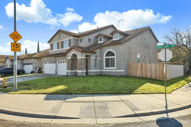 a view of a white house with a yard