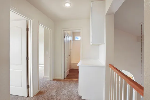 a bathroom with a bathtub shower sink vanity mirror and toilet