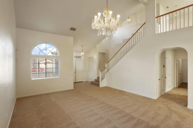 a view of an empty room with window and fireplace