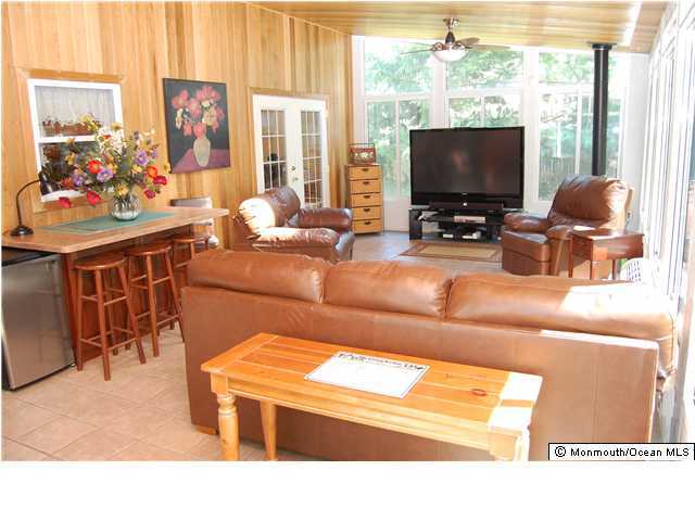 57 Ravatt Road Port Monmouth, NJ 07758 - Photo 3 of 3 a living room with furniture and a flat screen tv