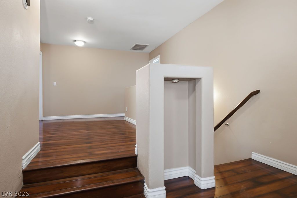 9712 North Running Rabbit Street Las Vegas, NV 89143 - Photo 26 of 42 Hardwood floors and a sleek banister guide the way up this inviting interior staircase.