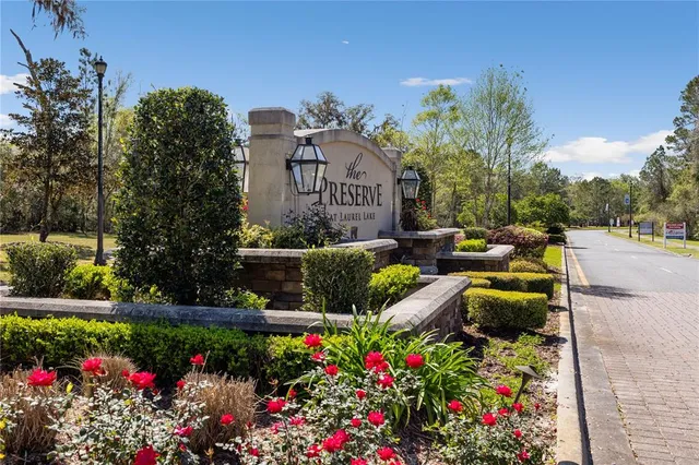 a view of a house with a big yard and potted plants