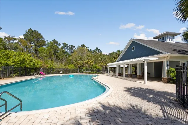 a view of a house with a backyard and a patio