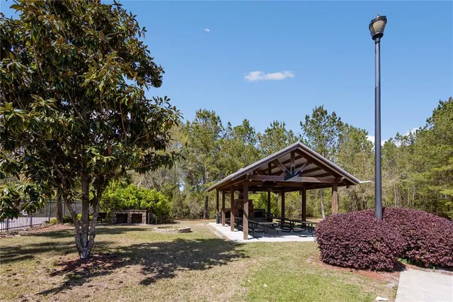 a view of a house with a tree in the background