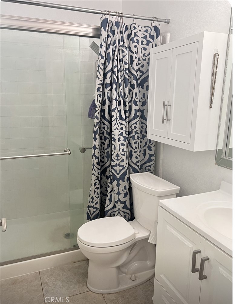 6848 Holbrook Way Riverside, CA 92504 - Photo 13 of 13 a white toilet sitting next to a shower curtain