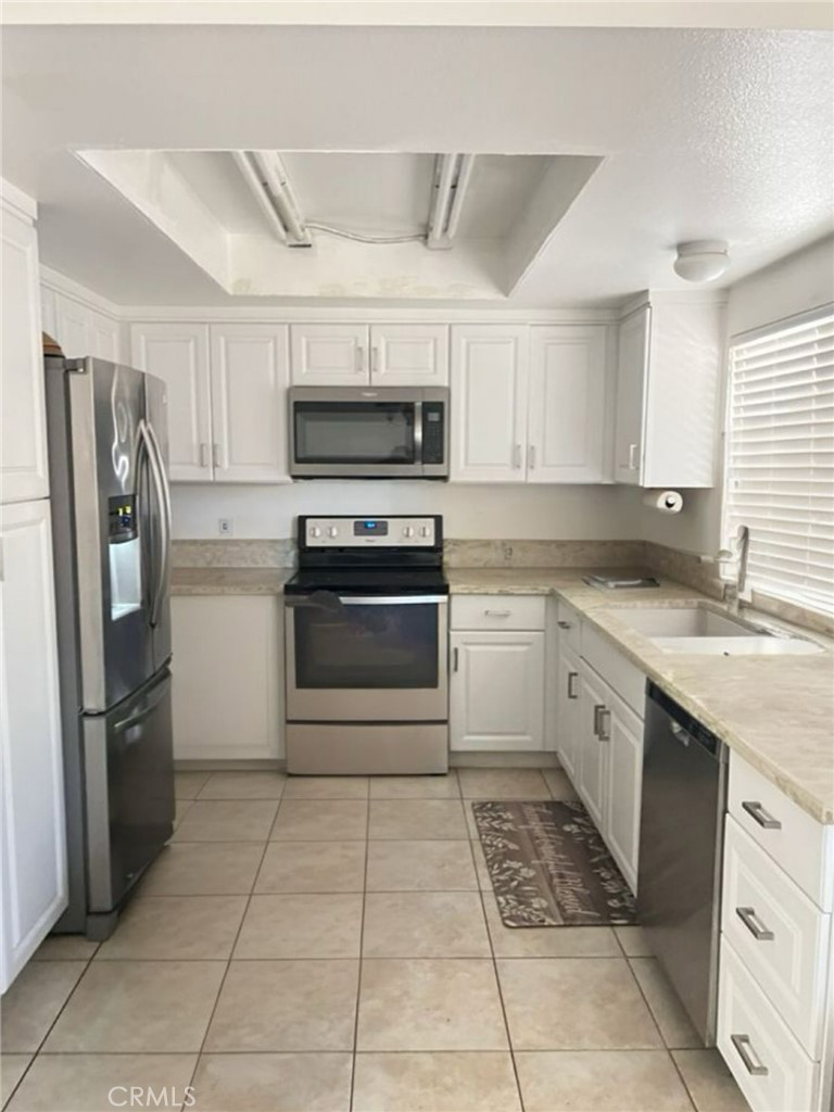 6848 Holbrook Way Riverside, CA 92504 - Photo 2 of 13 a kitchen with stainless steel appliances granite countertop a refrigerator and a stove top oven