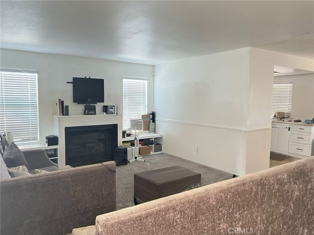 6848 Holbrook Way Riverside, CA 92504 - Photo 5 of 13 a living room with furniture and a flat screen tv