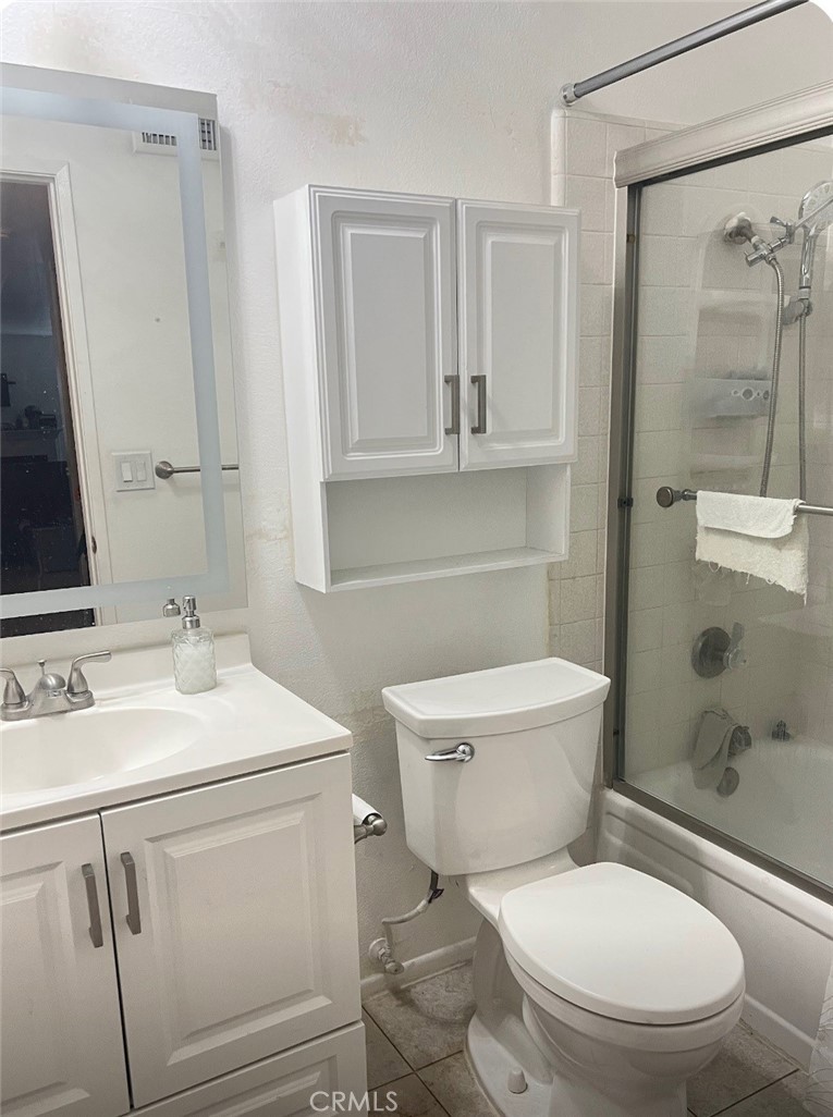 6848 Holbrook Way Riverside, CA 92504 - Photo 8 of 13 a white toilet sitting next to a bathroom sink