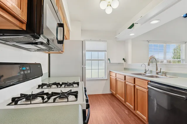 a kitchen with a sink stove and cabinets