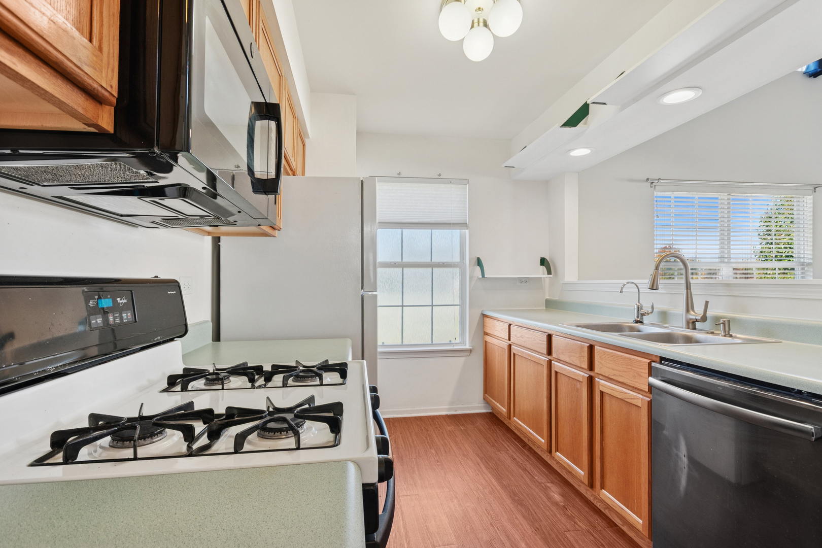 1919 Carousel Court, Unit 1919 Joliet, IL 60435 - Photo 12 of 20 a kitchen with a sink stove and cabinets