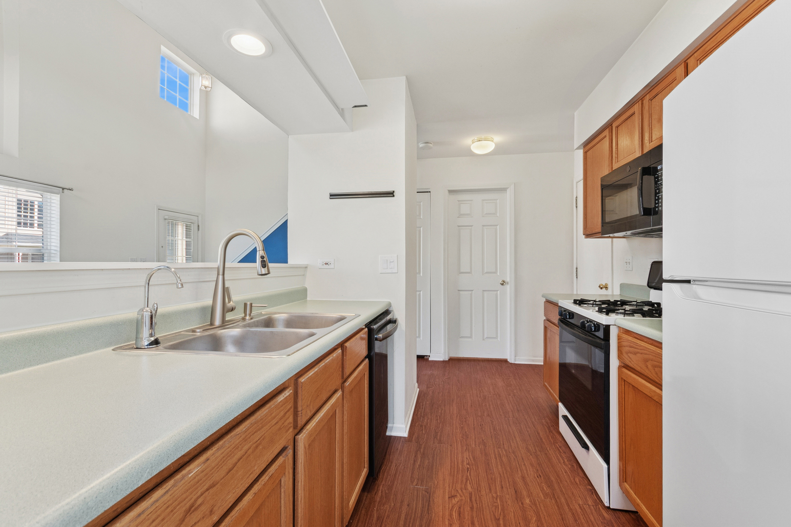 1919 Carousel Court, Unit 1919 Joliet, IL 60435 - Photo 13 of 20 a kitchen with stainless steel appliances granite countertop a sink stove and refrigerator