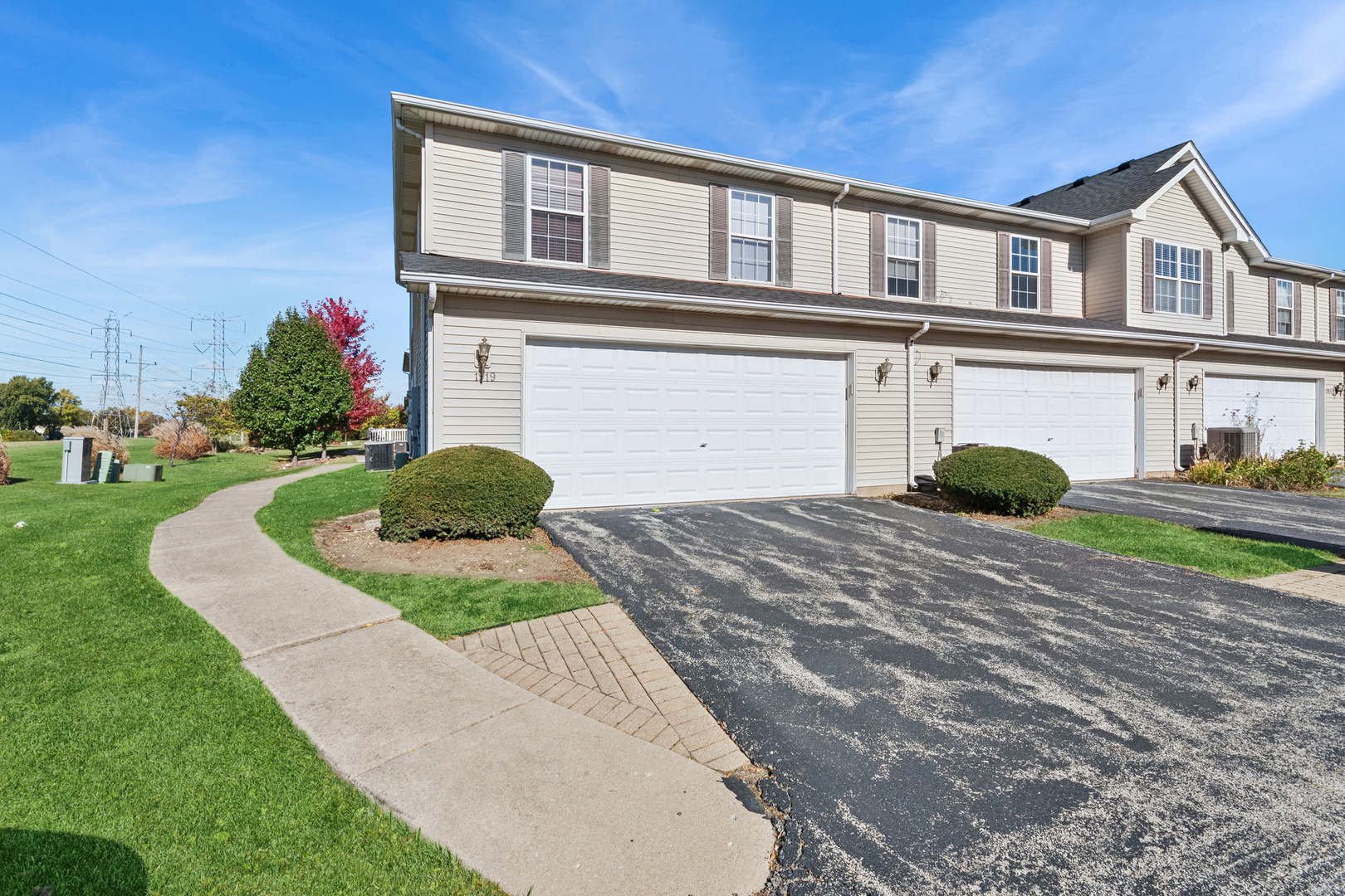 1919 Carousel Court, Unit 1919 Joliet, IL 60435 - Photo 3 of 20 a front view of a house with a yard and garage
