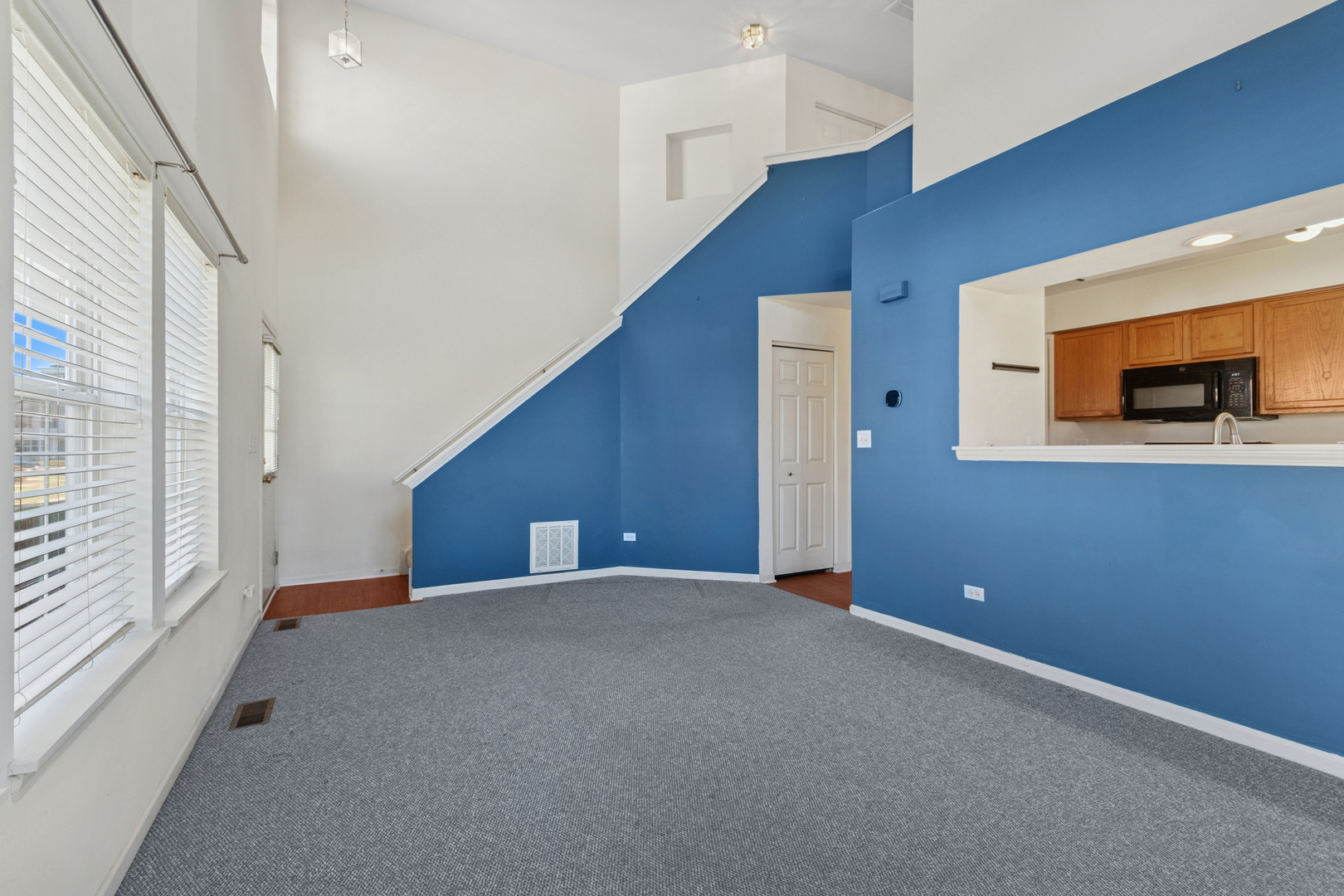 1919 Carousel Court, Unit 1919 Joliet, IL 60435 - Photo 7 of 20 a view of a livingroom with an empty space and a window