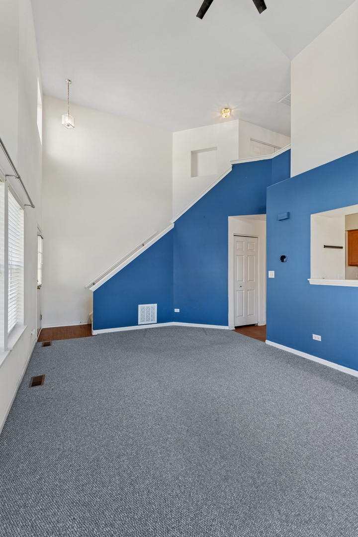 1919 Carousel Court, Unit 1919 Joliet, IL 60435 - Photo 8 of 20 a view of an empty room with windows