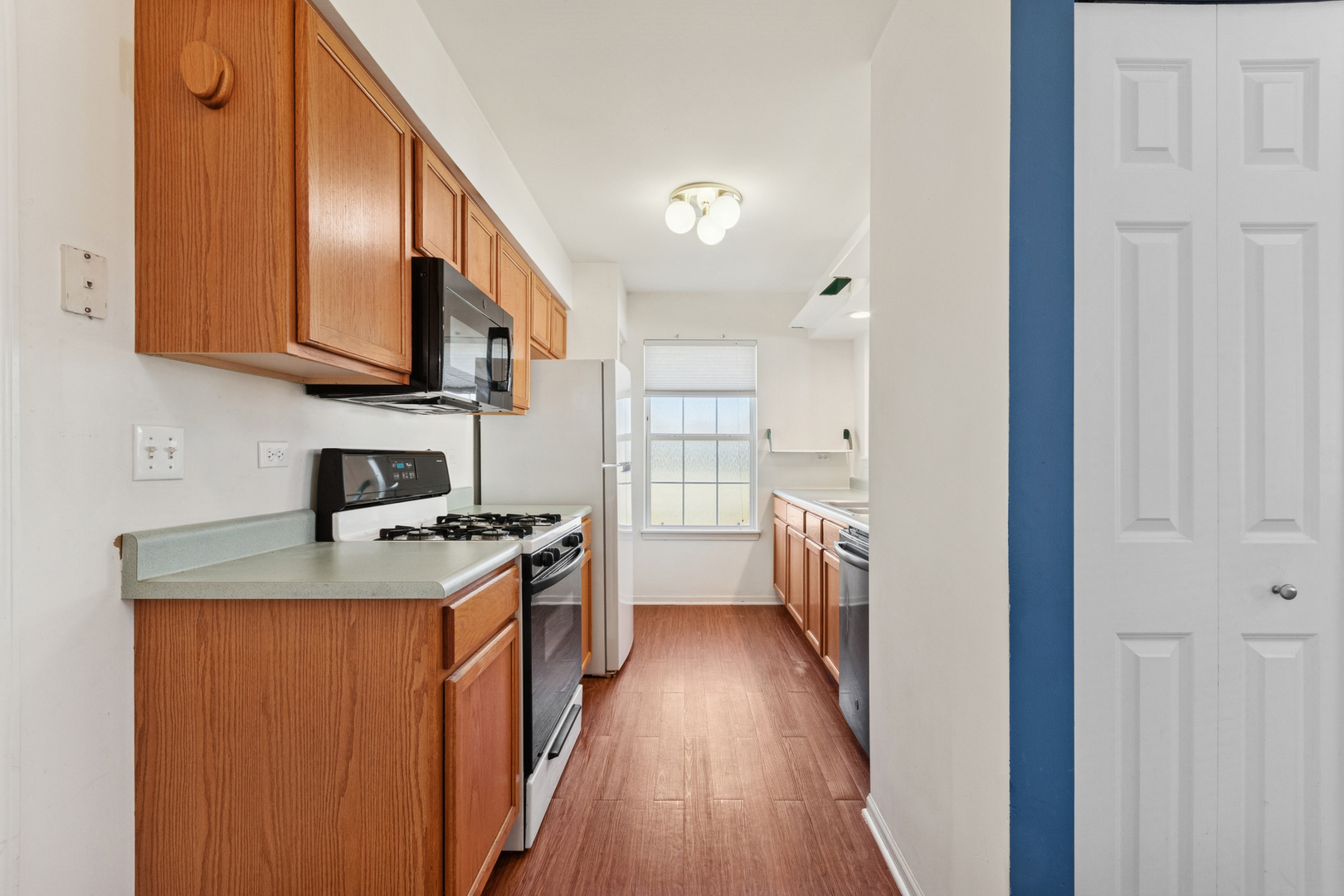 1919 Carousel Court, Unit 1919 Joliet, IL 60435 - Photo 10 of 20 a kitchen with stainless steel appliances granite countertop a stove a sink and a refrigerator