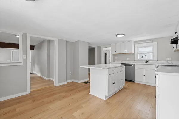 a kitchen with white cabinets and white appliances
