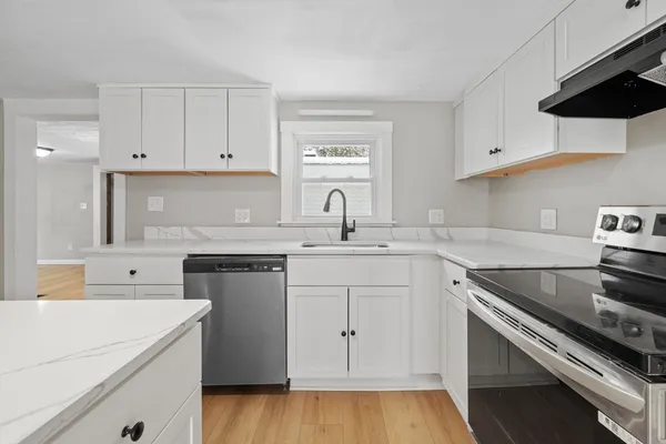 a kitchen with a sink stove and cabinets