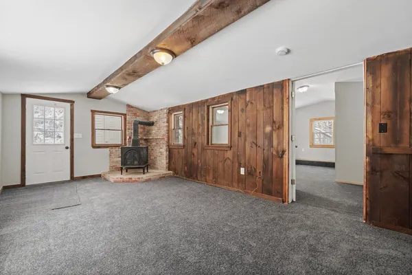 an empty room with closet and mirrors