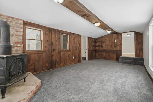 a living room with a fireplace and a window