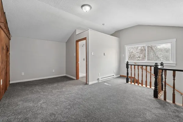 a view of a hallway with wooden floor and entryway