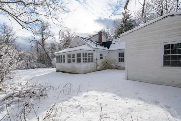 a view of a house with a snow in the yard