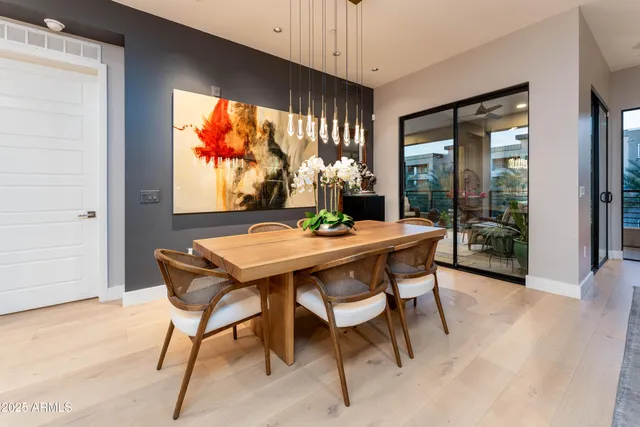 a dining room with furniture a window and wooden floor