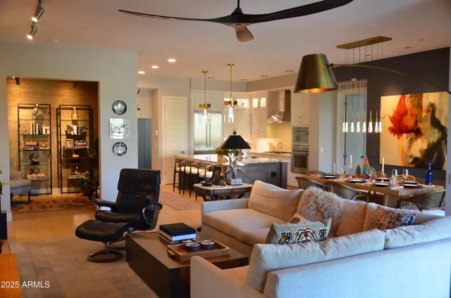 a living room with furniture gym equipment and a large window