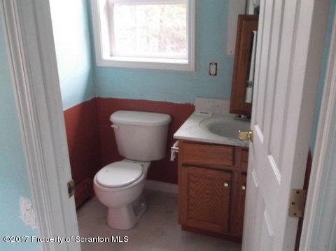 385 Rattlesnake Hill Road Meshoppen, PA 18630 - Photo 18 of 24 a bathroom with a toilet and a sink