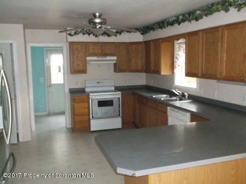385 Rattlesnake Hill Road Meshoppen, PA 18630 - Photo 10 of 24 a kitchen with stainless steel appliances granite countertop a stove a sink and a microwave