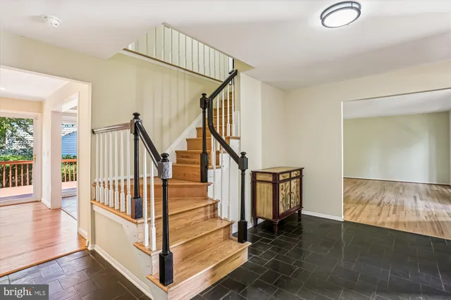 a living room with furniture mirror and a fireplace