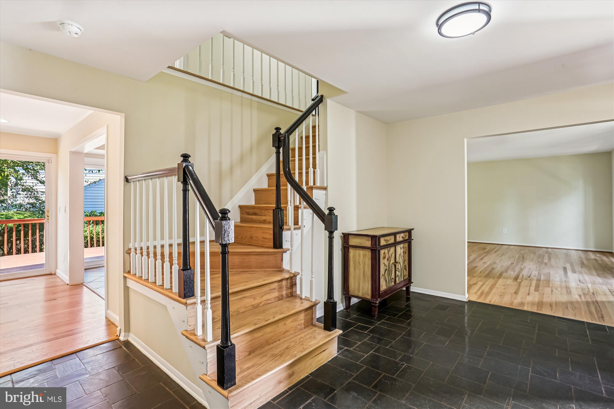a view of entryway and hall with wooden floor