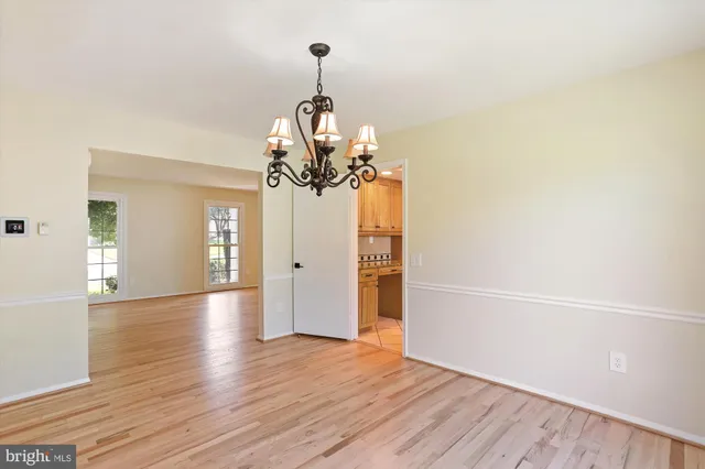 a view of a room with wooden floor and windows