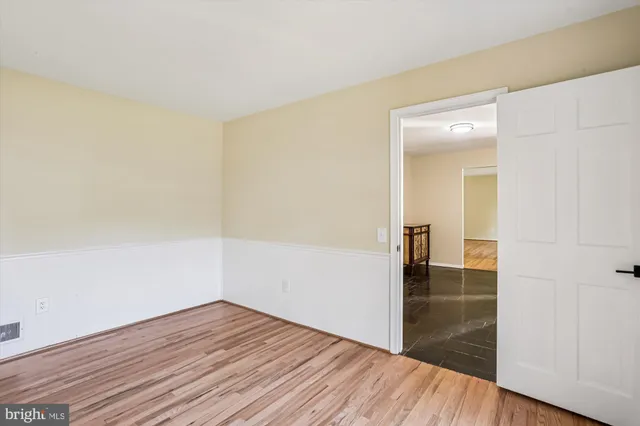 a view of a room with wooden floor