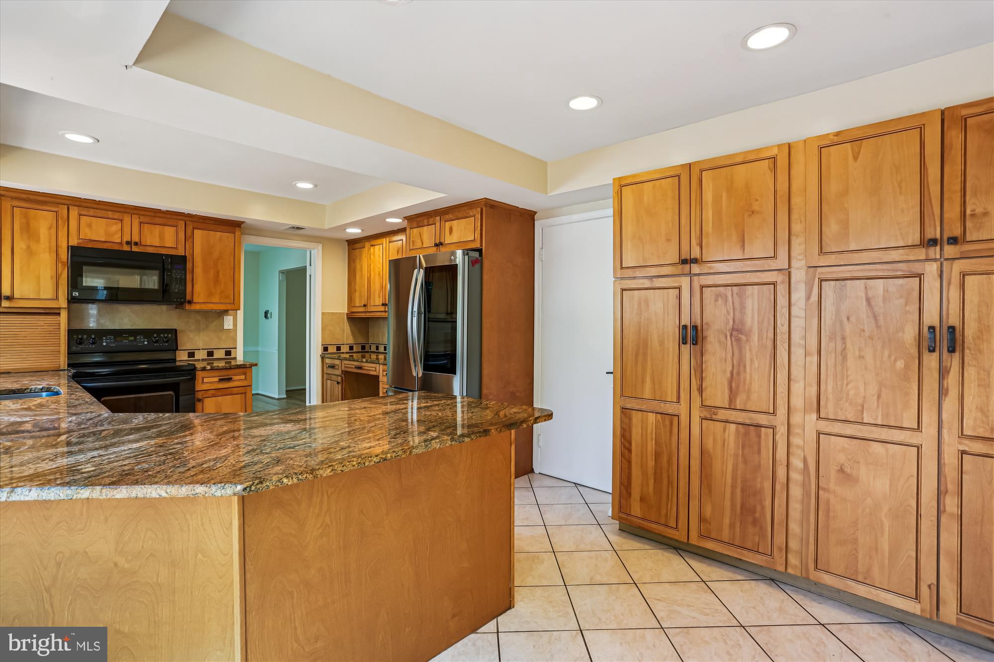9017 Falls Chapel Way Potomac, MD 20854 - Photo 27 of 70 a kitchen with stainless steel appliances granite countertop a refrigerator and a sink