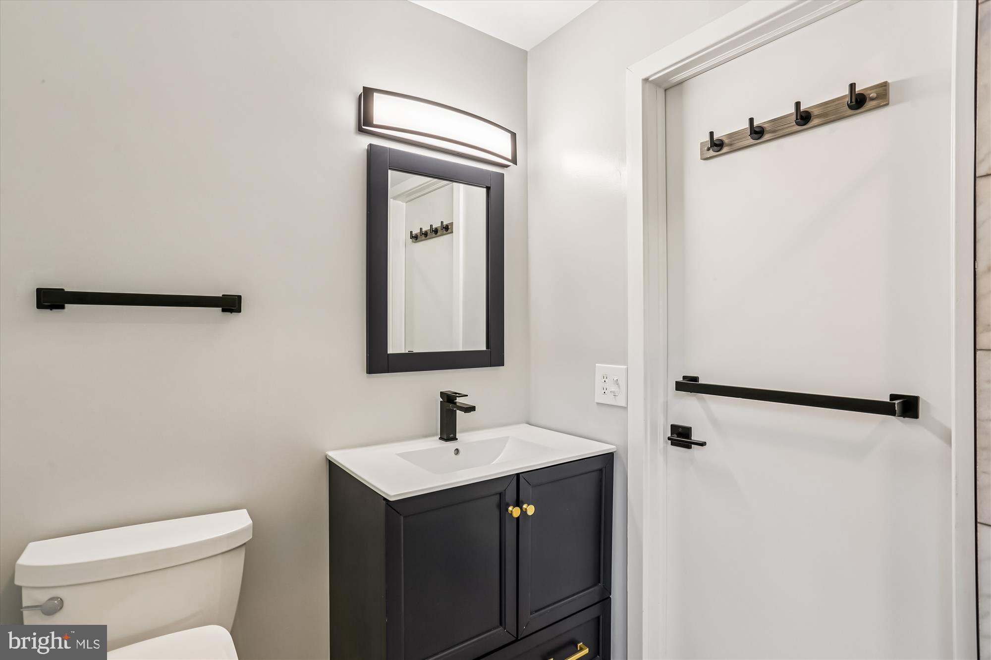 9017 Falls Chapel Way Potomac, MD 20854 - Photo 32 of 70 a bathroom with a toilet a sink and a mirror