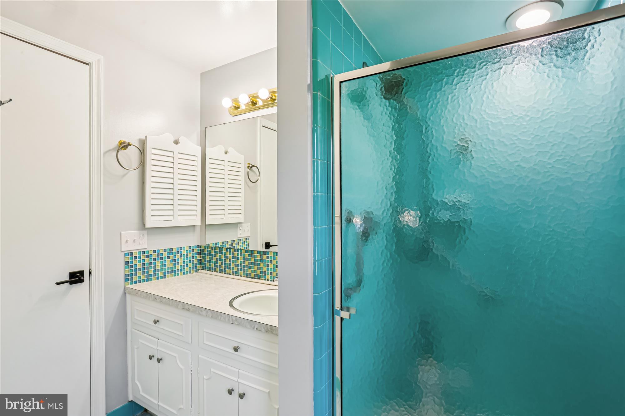 9017 Falls Chapel Way Potomac, MD 20854 - Photo 41 of 70 a bathroom with a granite countertop shower sink and mirror