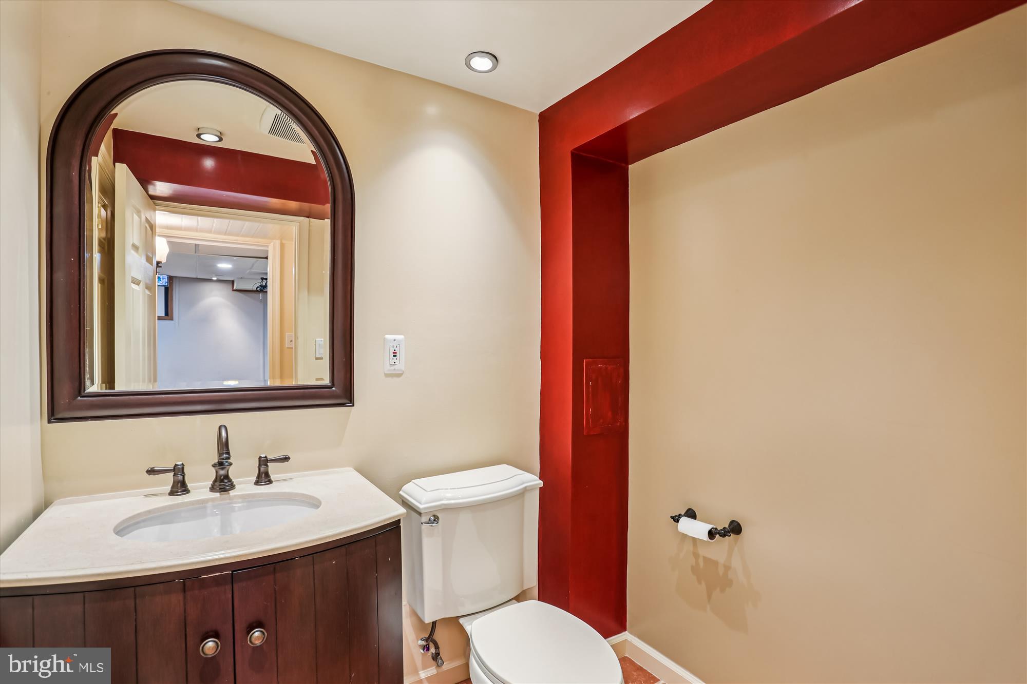 9017 Falls Chapel Way Potomac, MD 20854 - Photo 61 of 70 a bathroom with a toilet sink and mirror