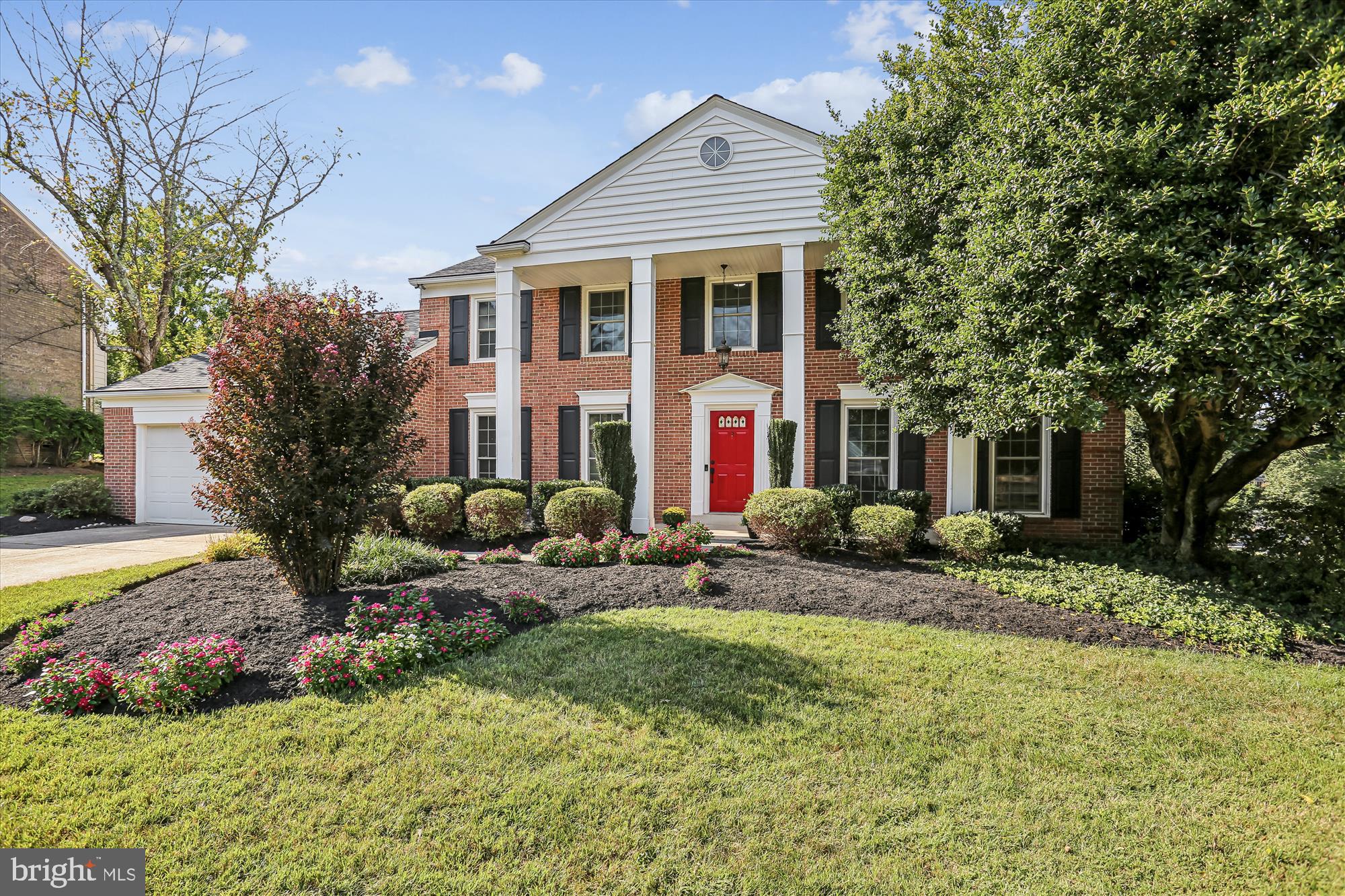 9017 Falls Chapel Way Potomac, MD 20854 - Photo 9 of 70 a view of a house with a yard and lawn chairs under an umbrella