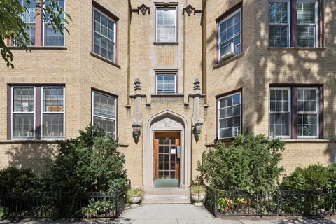 a view of a brick building next to a yard