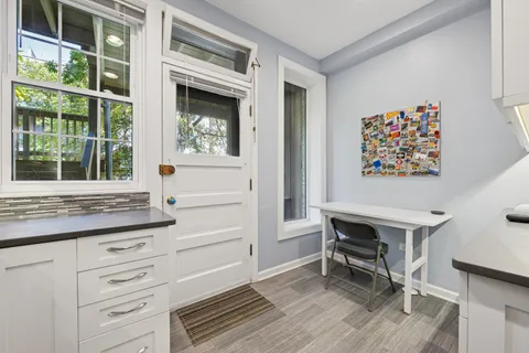 a view of a hallway with cabinet and a window