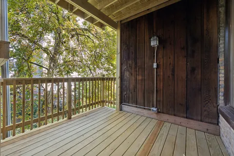 a view of balcony with wooden floor