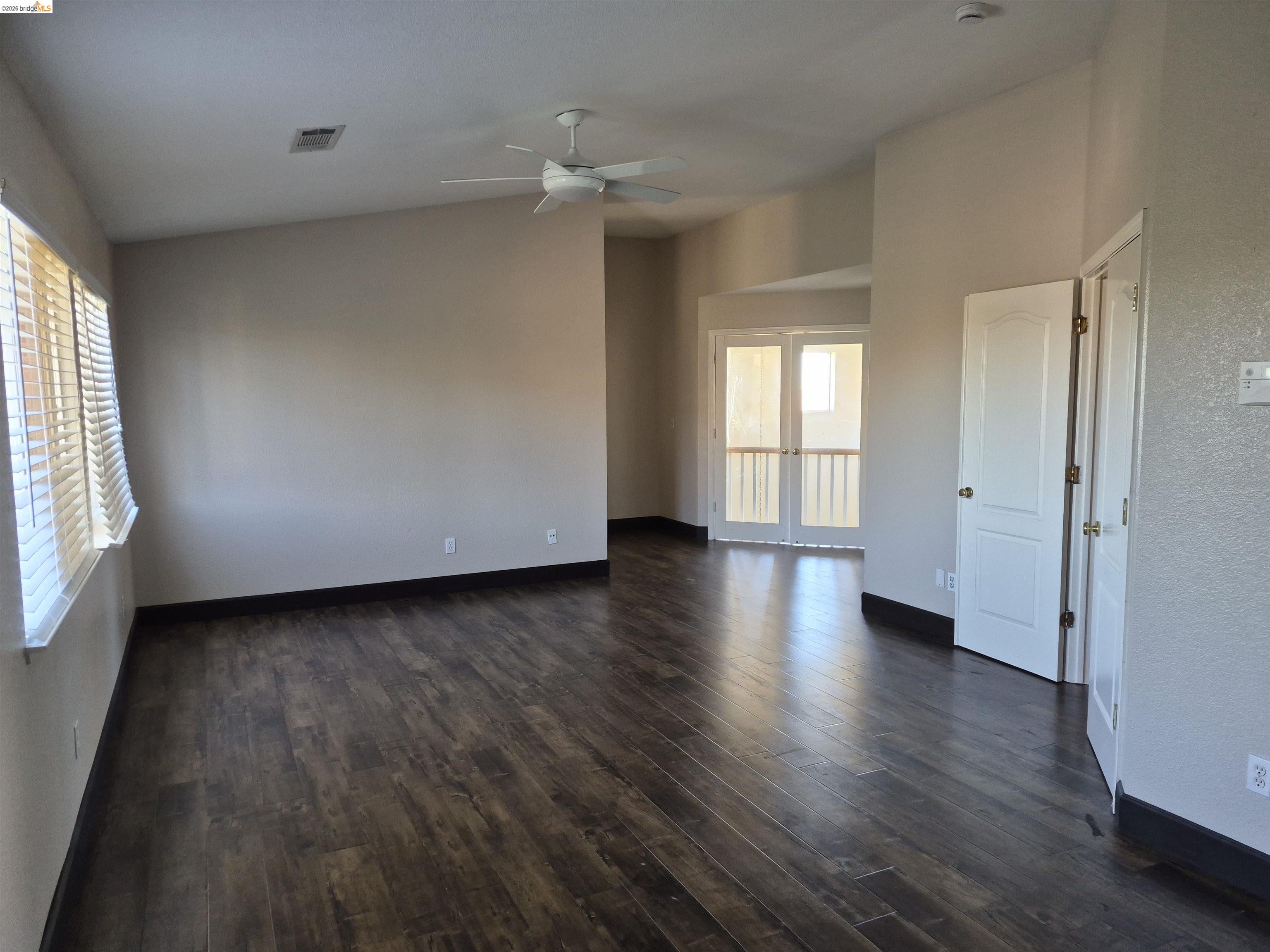 149 Oakpoint Court Bay Point, CA 94565 - Photo 8 of 22 Spacious room featuring wood-finish flooring, a contemporary ceiling fan, and sloped ceilings