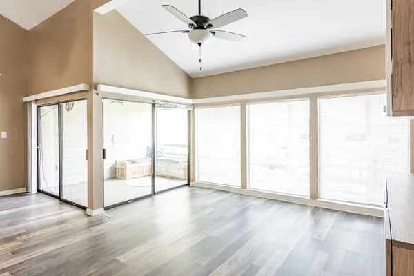 wooden floor in an empty room with a window