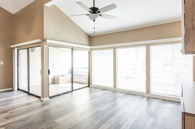 wooden floor in an empty room with a window