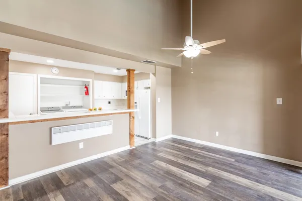 a view of kitchen cabinets and wooden floor