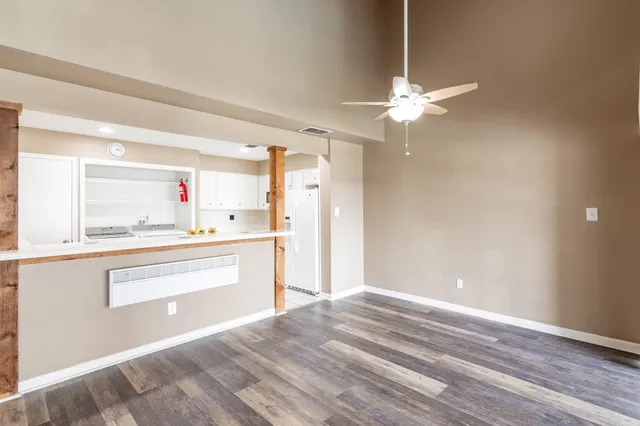 a view of kitchen cabinets and wooden floor