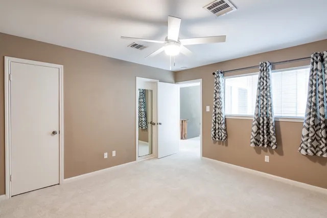 an empty room with windows and closet