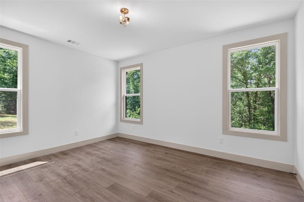 1416 Morgan Road Bremen, GA 30110 - Photo 26 of 32 a view of an empty room with wooden floor and a window